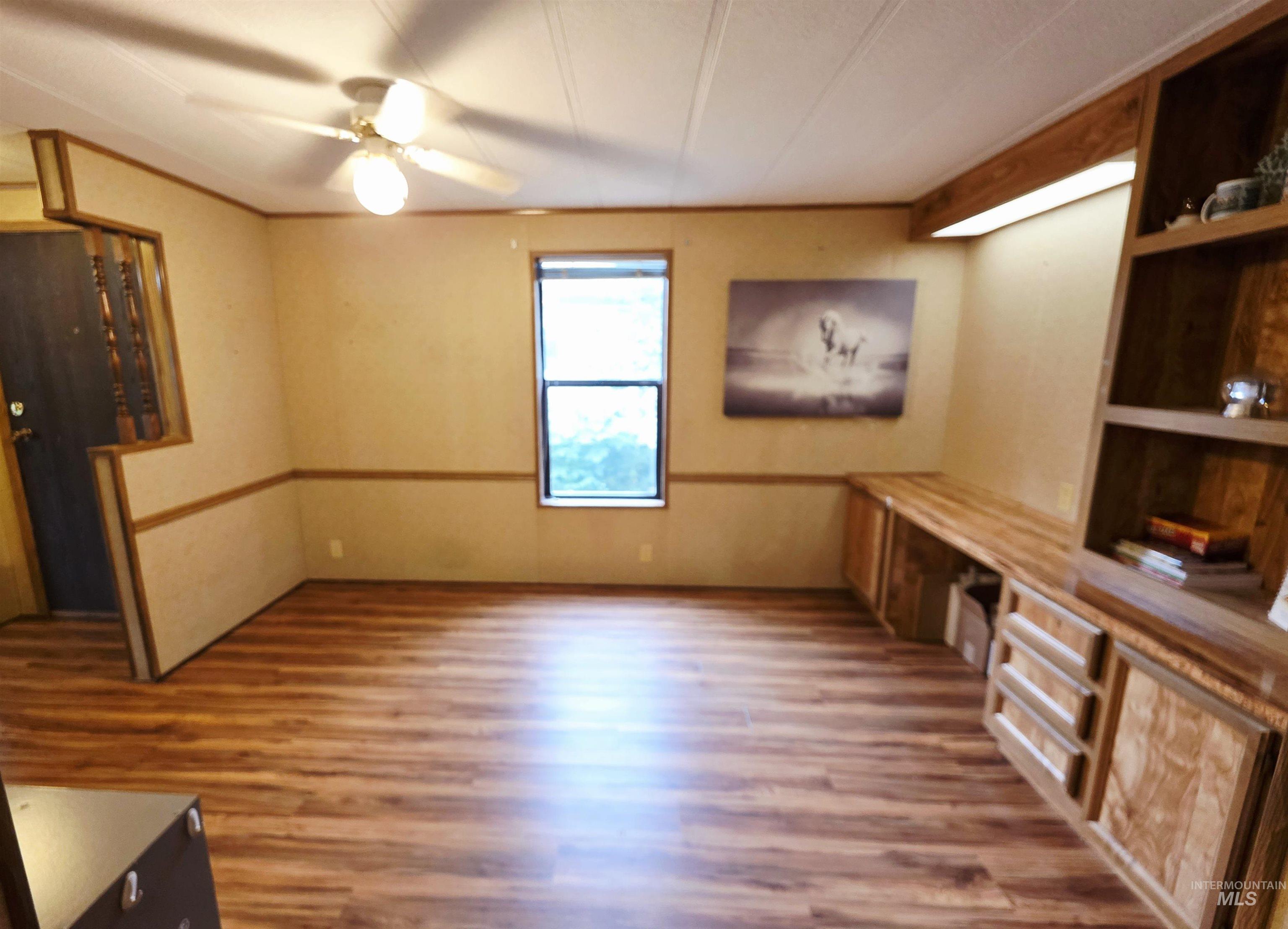 2015 6th Avenue, Unit 14 Clarkston, WA 99403 - Photo 14 of 27 Unfurnished office featuring built in study area, dark wood finished floors, ceiling fan, and ornamental molding