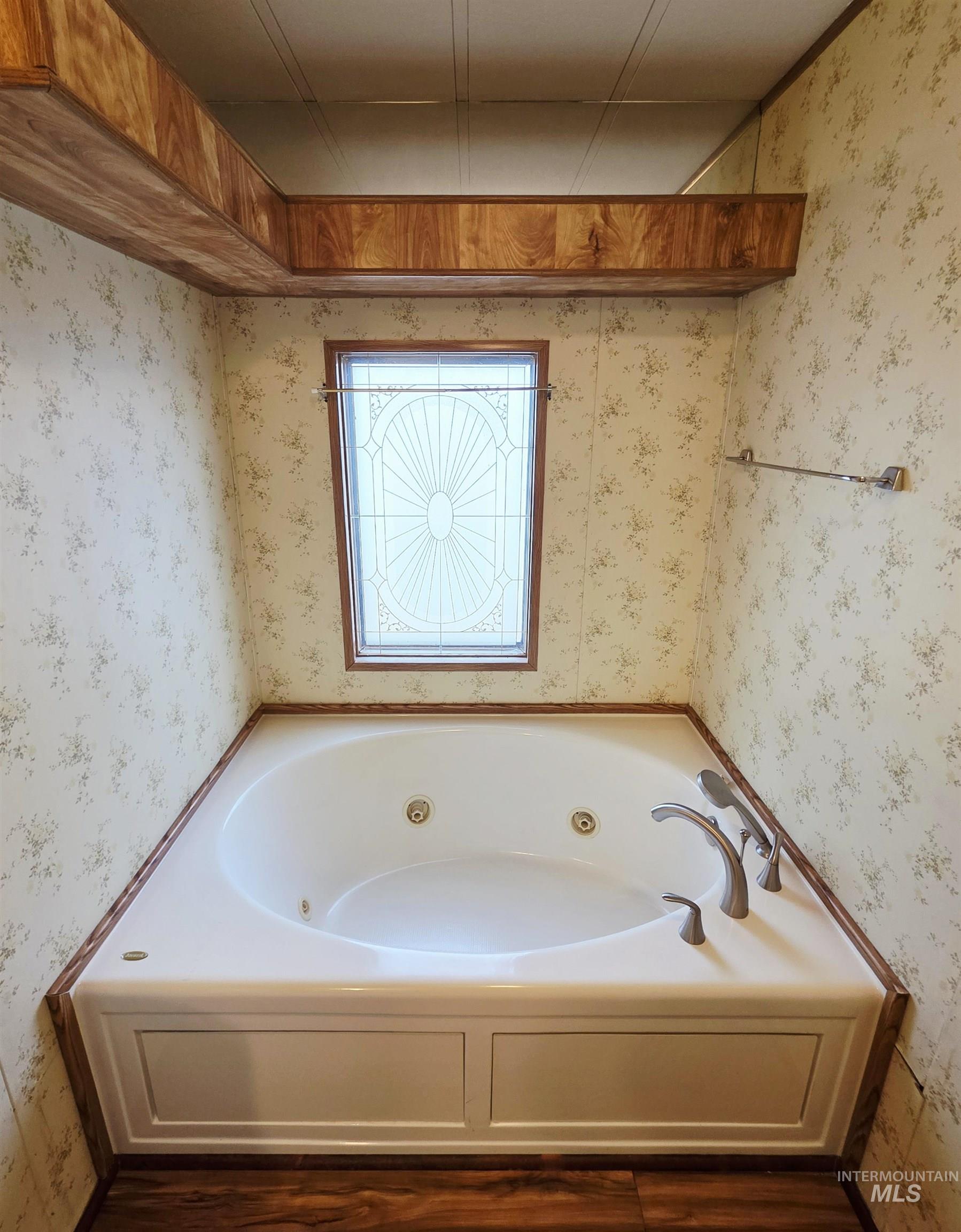 2015 6th Avenue, Unit 14 Clarkston, WA 99403 - Photo 21 of 27 Bathroom featuring a tub with jets, wallpapered walls, and dark wood finished floors