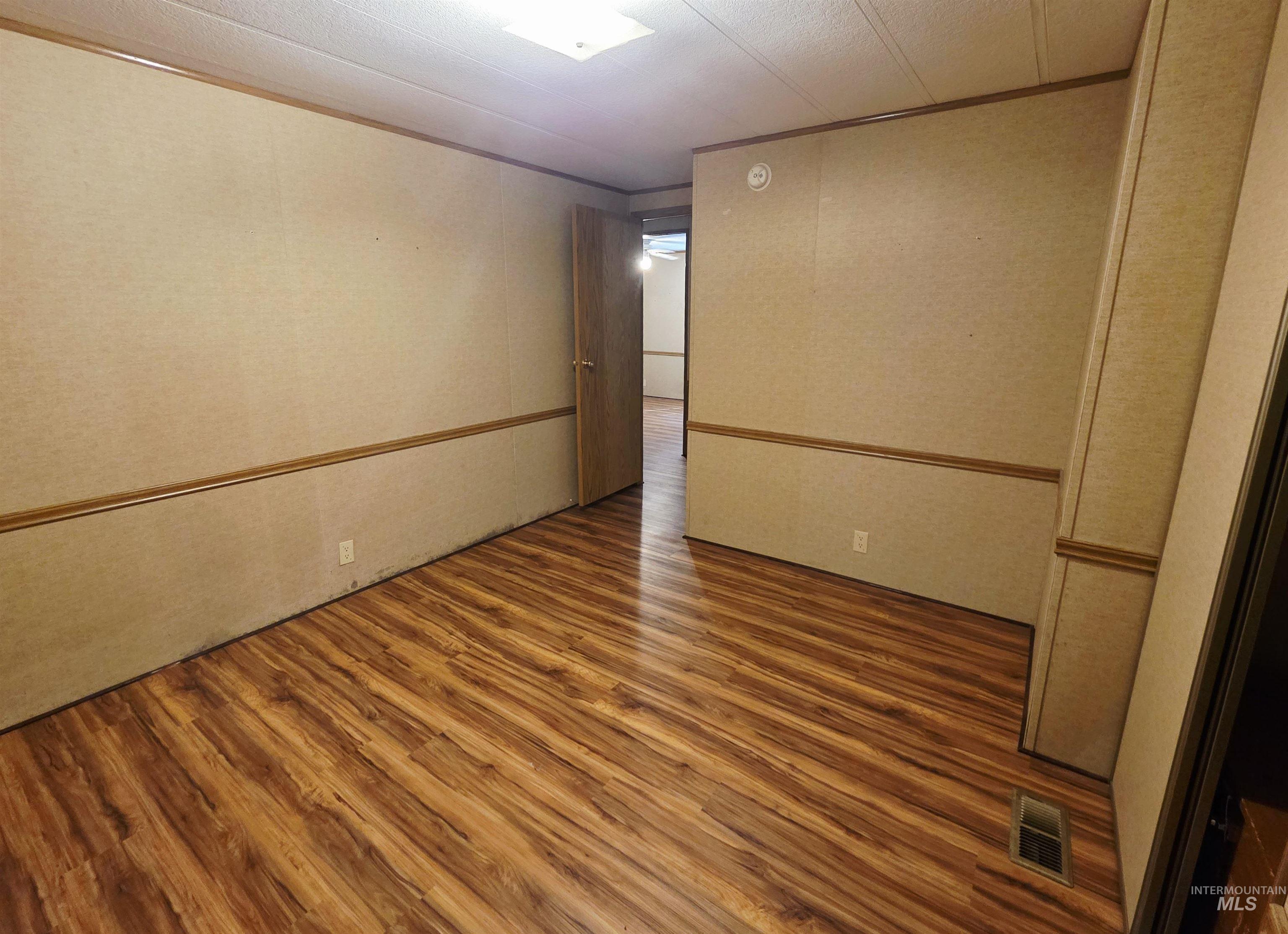 2015 6th Avenue, Unit 14 Clarkston, WA 99403 - Photo 23 of 27 Spare room with wood finished floors and crown molding