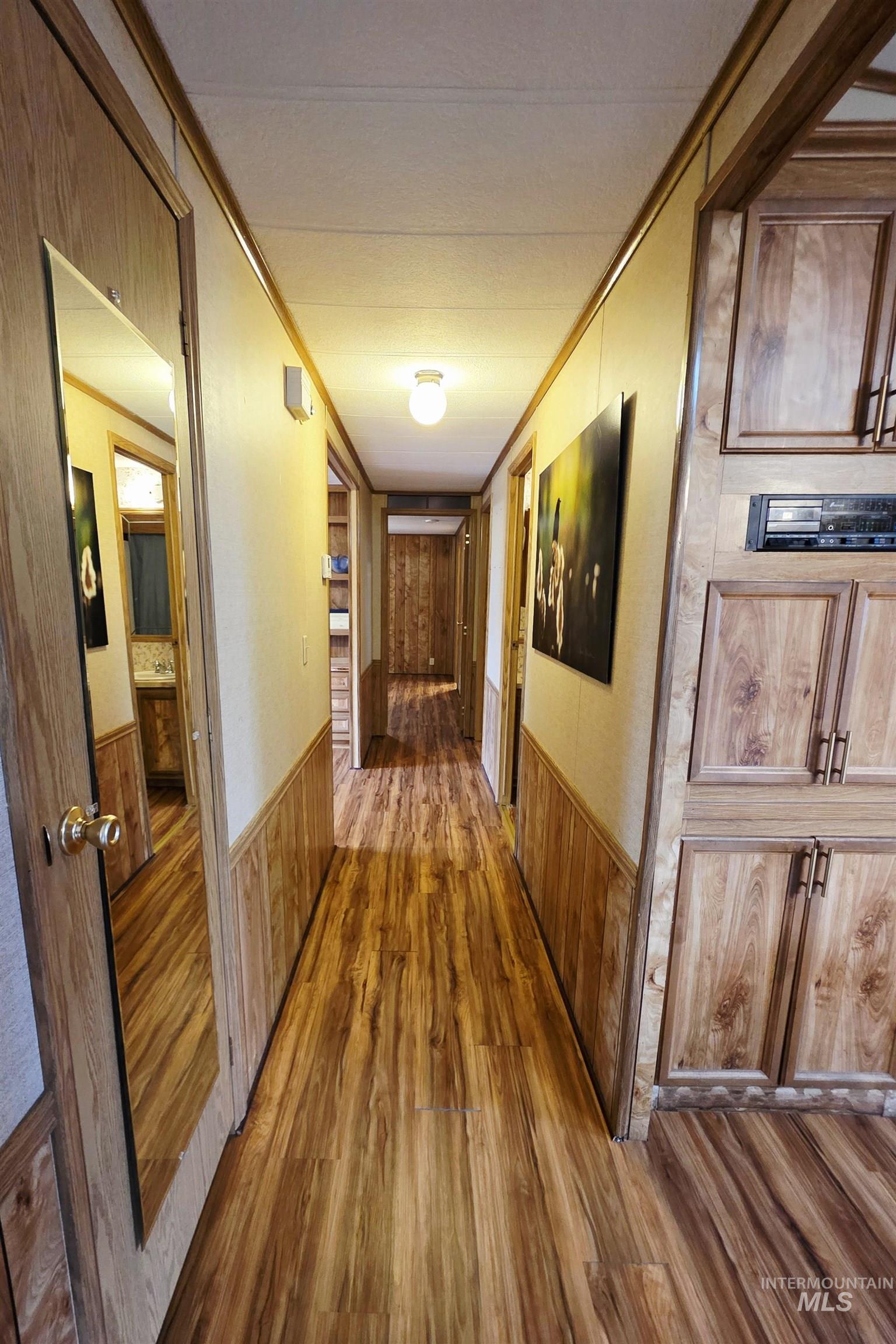2015 6th Avenue, Unit 14 Clarkston, WA 99403 - Photo 25 of 27 Hall featuring wood finished floors, crown molding, wainscoting, and wood walls