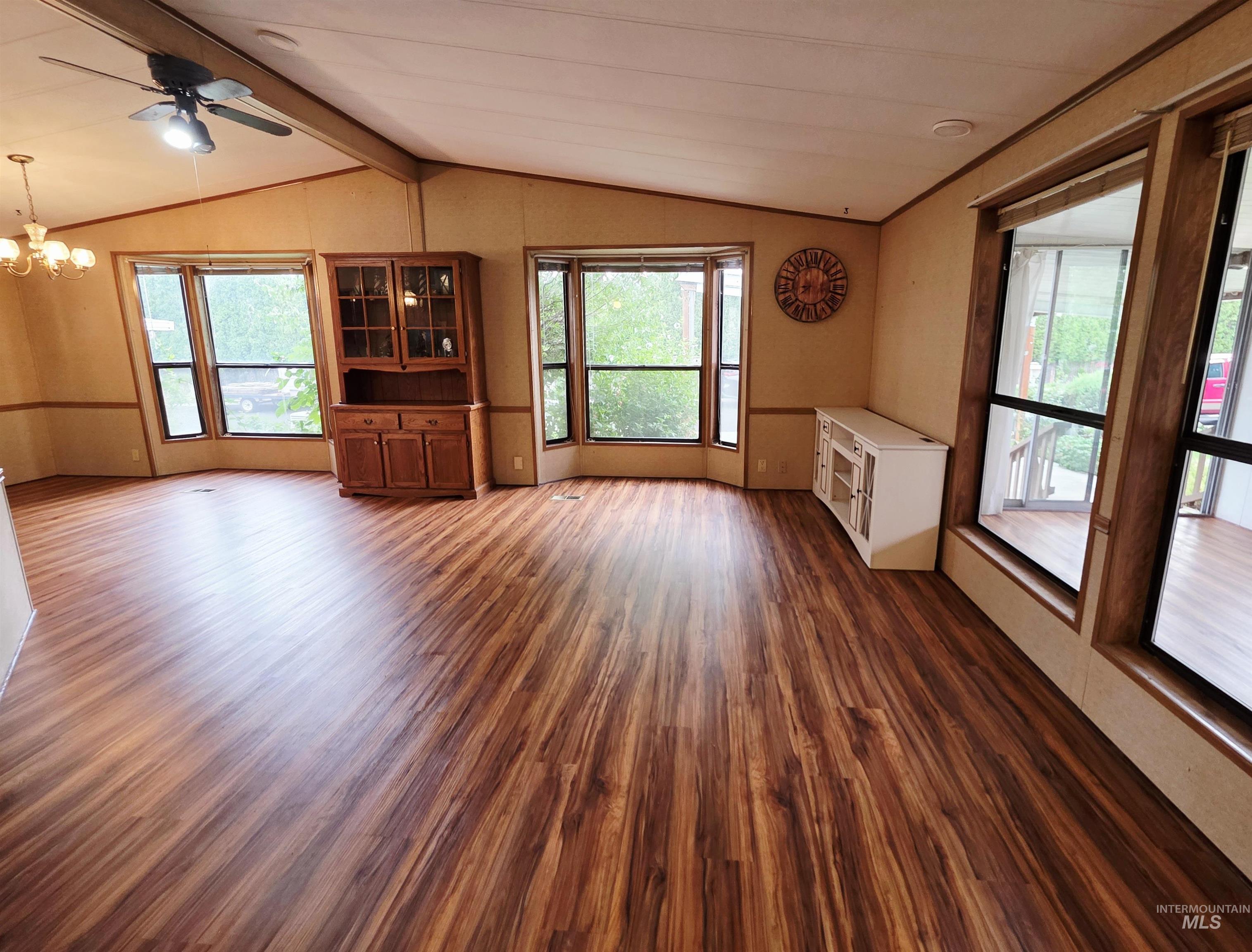 2015 6th Avenue, Unit 14 Clarkston, WA 99403 - Photo 4 of 27 Unfurnished living room with dark wood finished floors, a chandelier, and ceiling fan