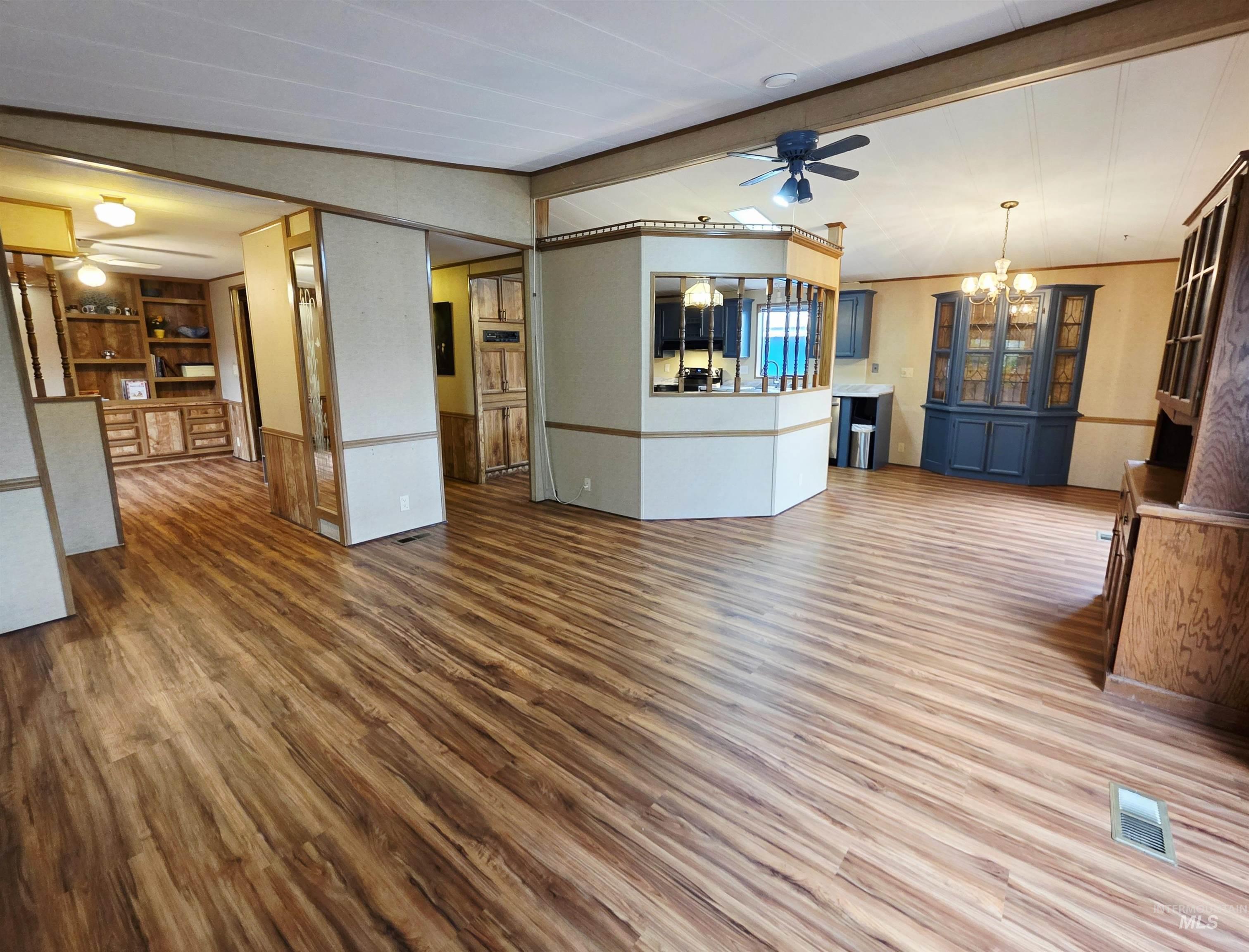 2015 6th Avenue, Unit 14 Clarkston, WA 99403 - Photo 5 of 27 Unfurnished living room featuring a ceiling fan, a chandelier, and wood finished floors