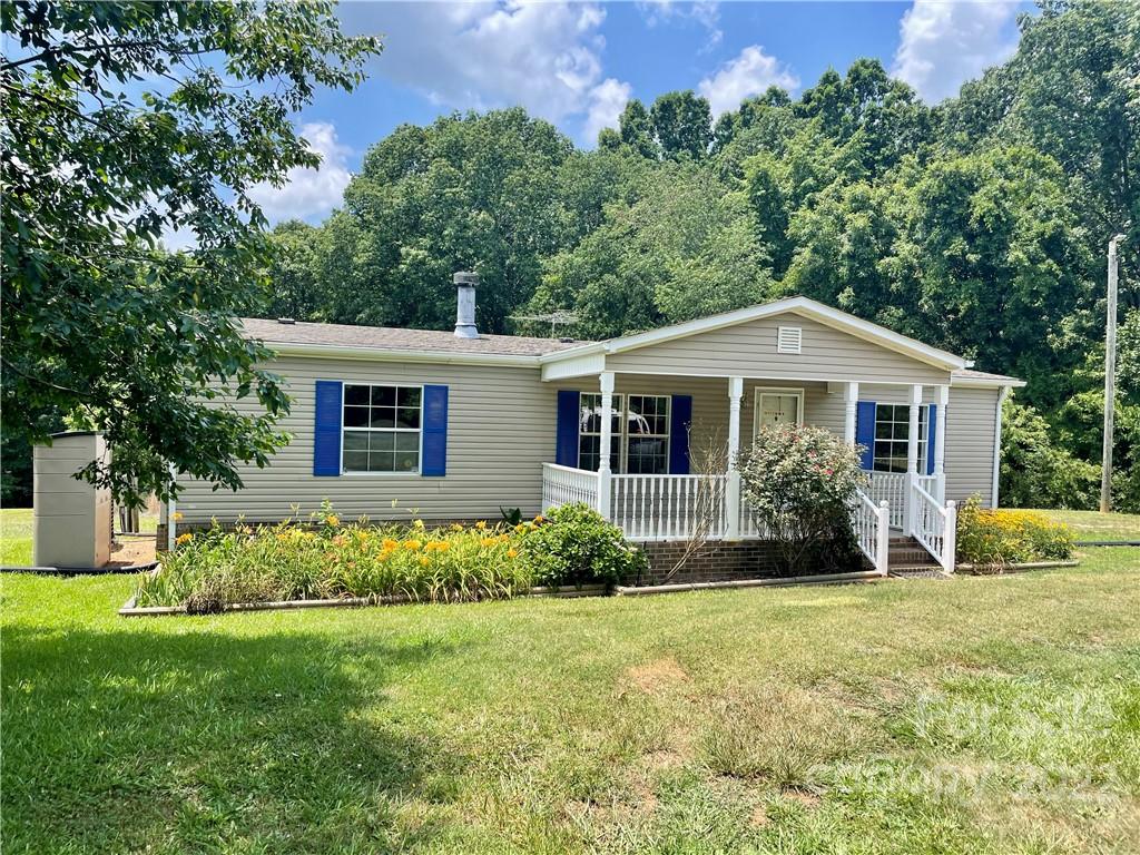 1255 Colonial Road Clover, SC 29710 - Photo 1 of 20 a front view of a house with garden
