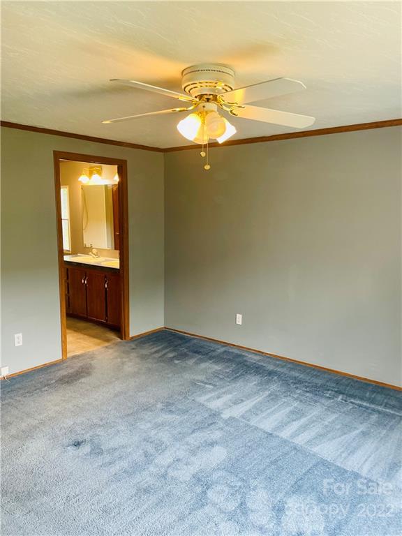 1255 Colonial Road Clover, SC 29710 - Photo 11 of 20 an empty room with a chandelier fan and windows