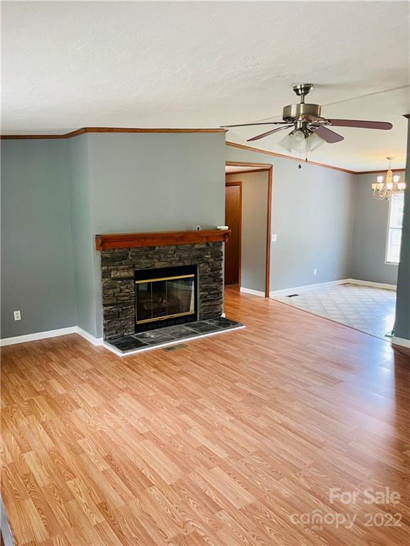 1255 Colonial Road Clover, SC 29710 - Photo 2 of 20 a view of empty room with a fireplace and wooden floor