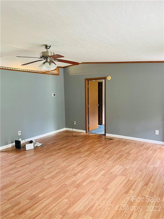 1255 Colonial Road Clover, SC 29710 - Photo 3 of 20 a view of an empty room with wooden floor and a window