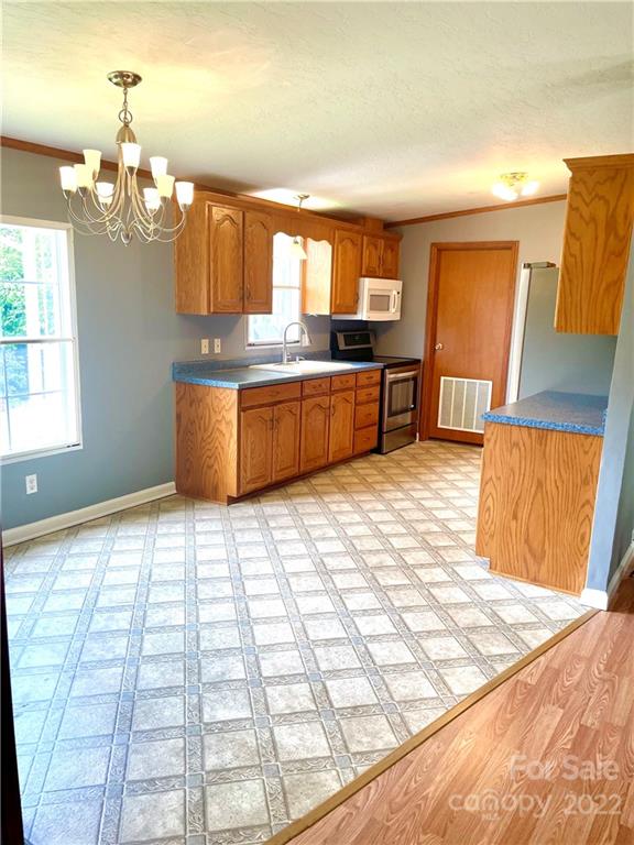 1255 Colonial Road Clover, SC 29710 - Photo 4 of 20 a kitchen with stainless steel appliances kitchen island granite countertop a refrigerator and stove