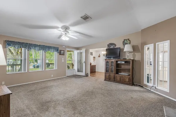 a view of a kitchen with furniture and a ceiling fan