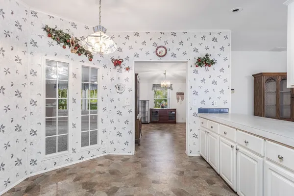 a spacious bathroom with a granite countertop sink a mirror and shower