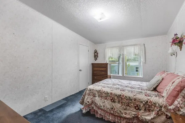 a bedroom with a large bed and a window
