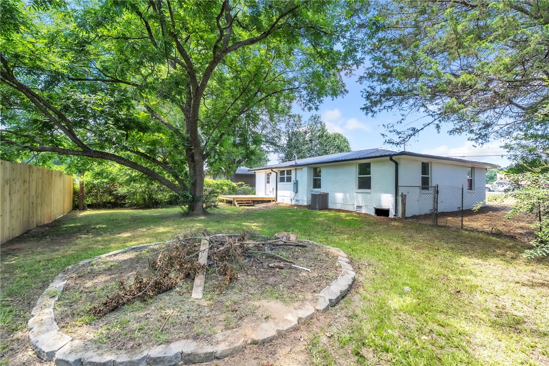 7 Beaverdam Road Williamston, SC 29697 - Photo 4 of 27 A spacious backyard with mature trees and a charming deck awaits.