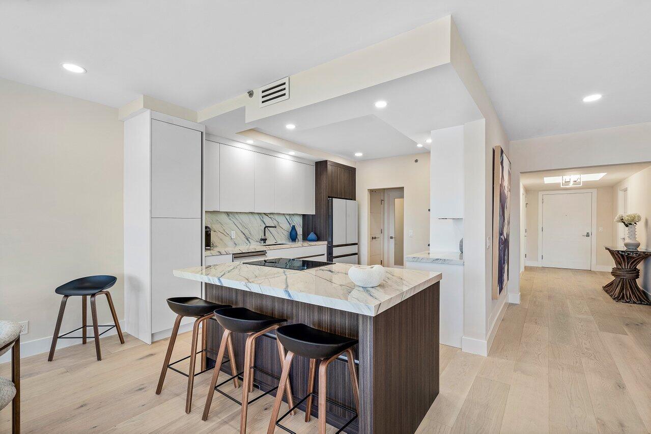 100 Mac Farlane Drive, Unit 2A Delray Beach, FL 33483 - Photo 11 of 28 a view of a kitchen area with furniture and wooden floor