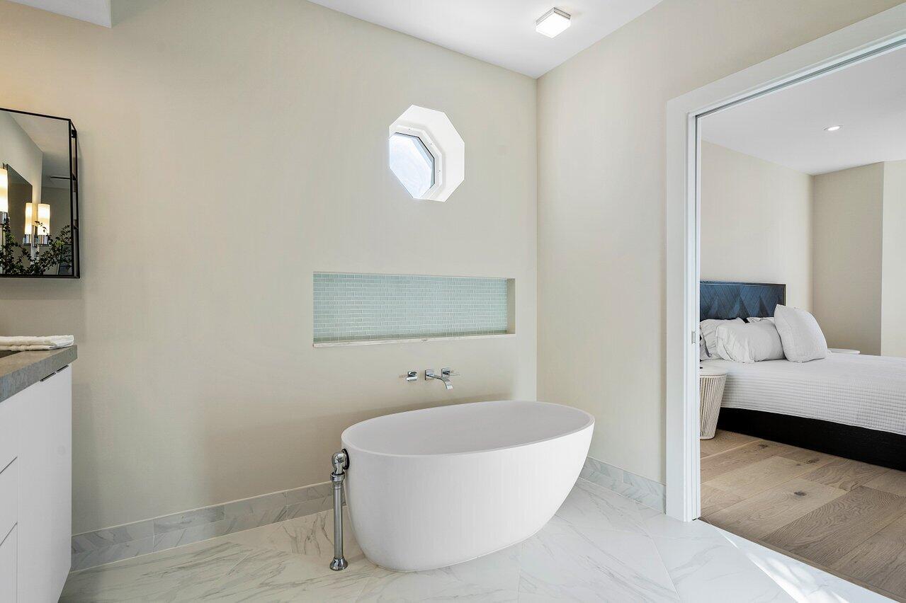 100 Mac Farlane Drive, Unit 2A Delray Beach, FL 33483 - Photo 19 of 28 a bathroom with a tub and a sink