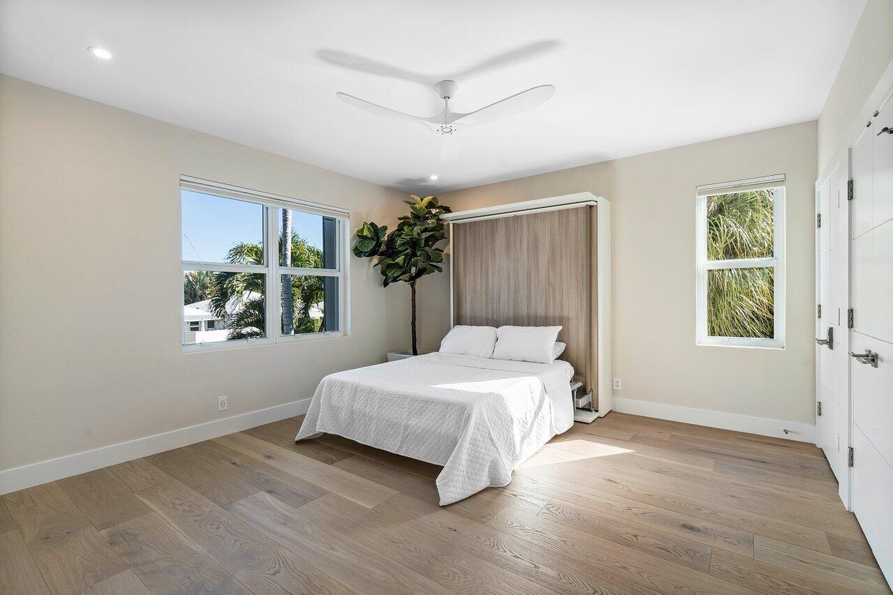 100 Mac Farlane Drive, Unit 2A Delray Beach, FL 33483 - Photo 20 of 28 a bedroom with a large bed and a window