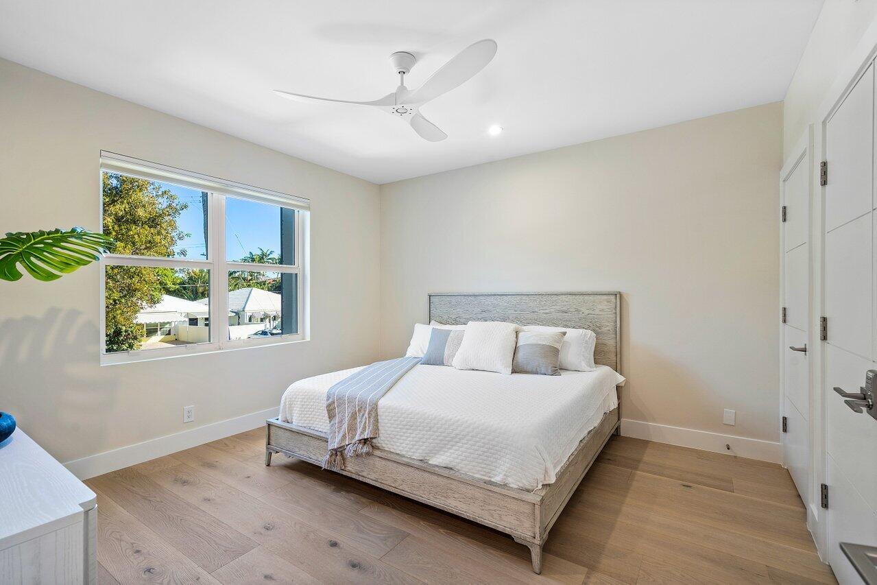 100 Mac Farlane Drive, Unit 2A Delray Beach, FL 33483 - Photo 24 of 28 a bedroom with a bed and a window