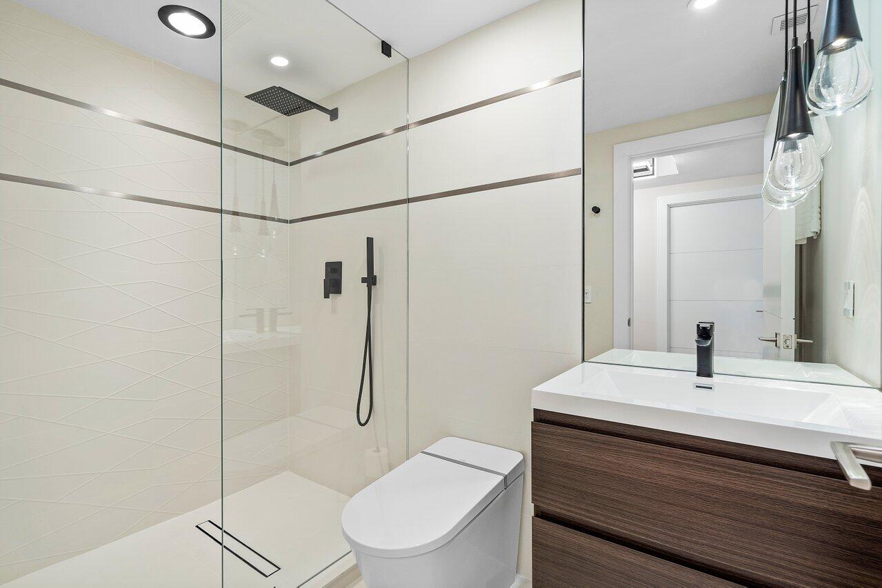 100 Mac Farlane Drive, Unit 2A Delray Beach, FL 33483 - Photo 25 of 28 a bathroom with a sink toilet and shower