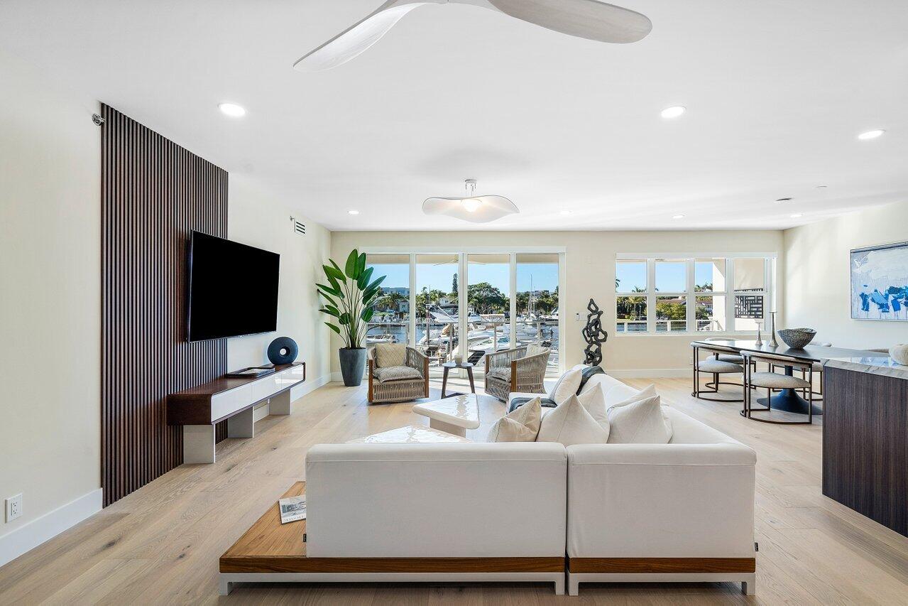 100 Mac Farlane Drive, Unit 2A Delray Beach, FL 33483 - Photo 5 of 28 a living room with furniture and a flat screen tv