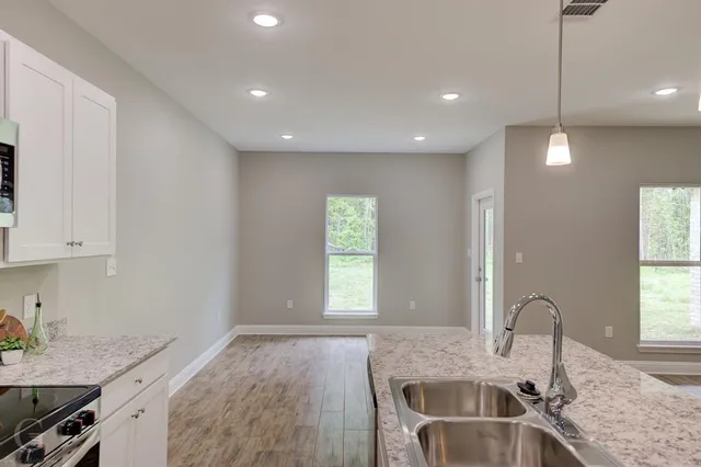 an empty room with a ceiling fan and window