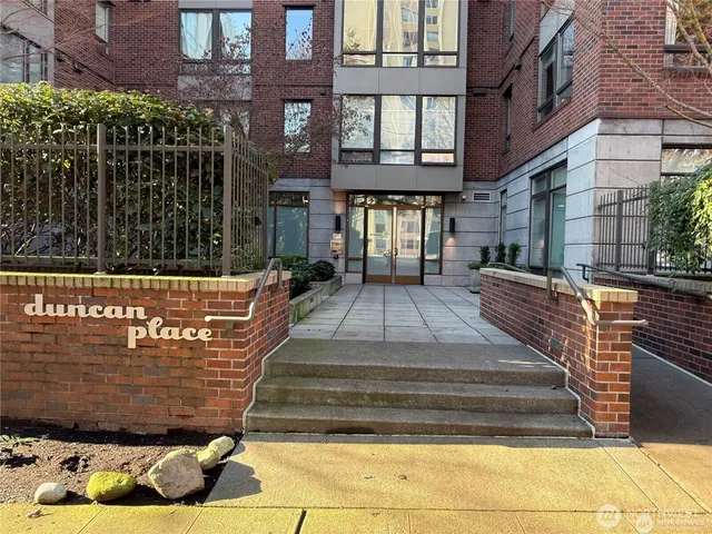 a view of a brick building with many windows