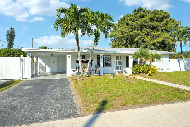 a view of a house with pool and sitting area