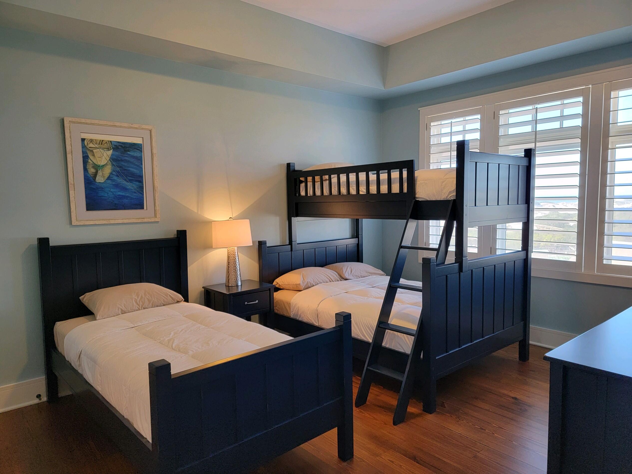 99 Compass Point Way South, Unit 402 Inlet Beach, FL 32461 - Photo 12 of 36 a bedroom with two beds and a lamp on table