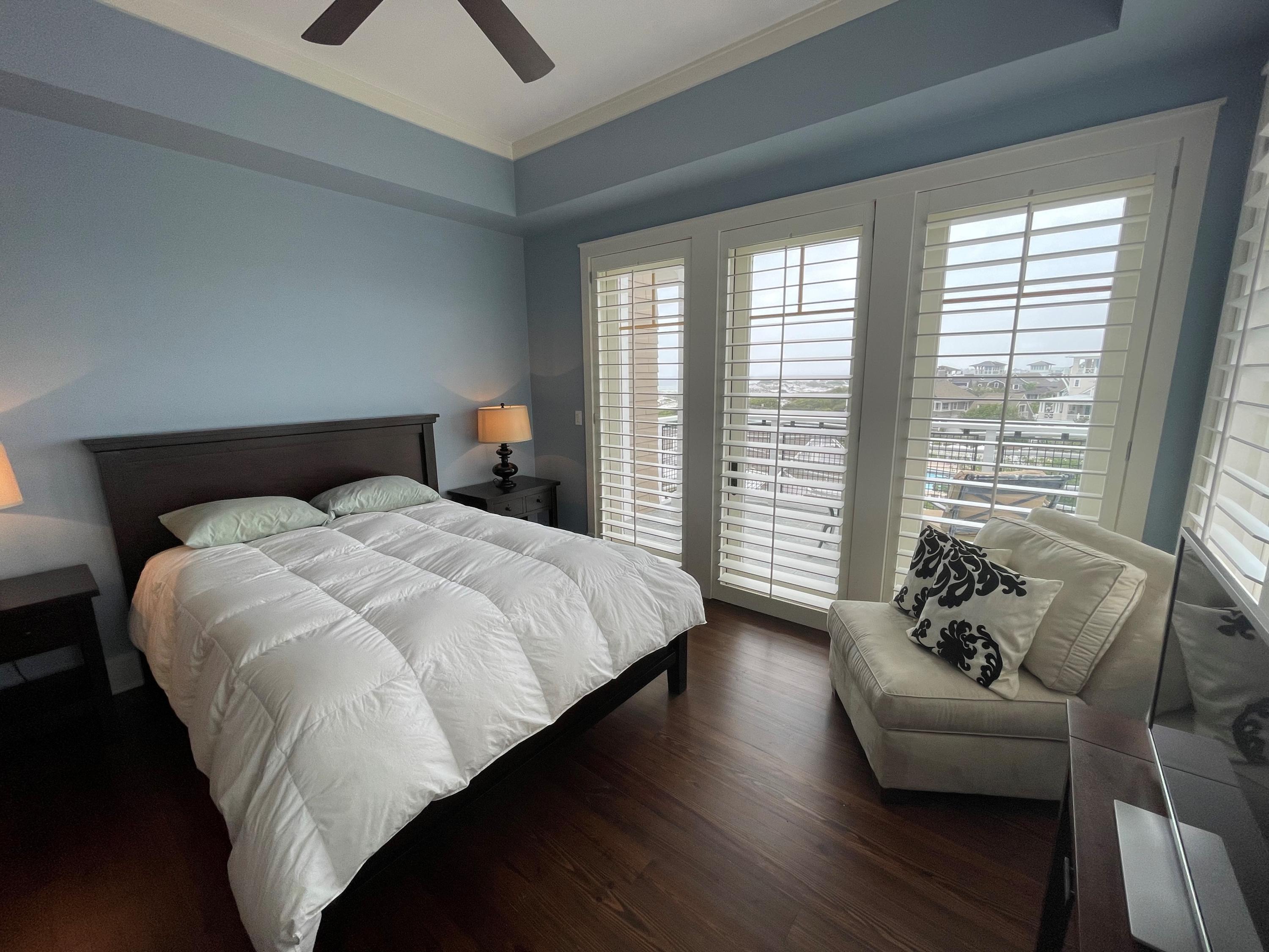 99 Compass Point Way South, Unit 402 Inlet Beach, FL 32461 - Photo 19 of 36 a bedroom with a bed and wooden floor