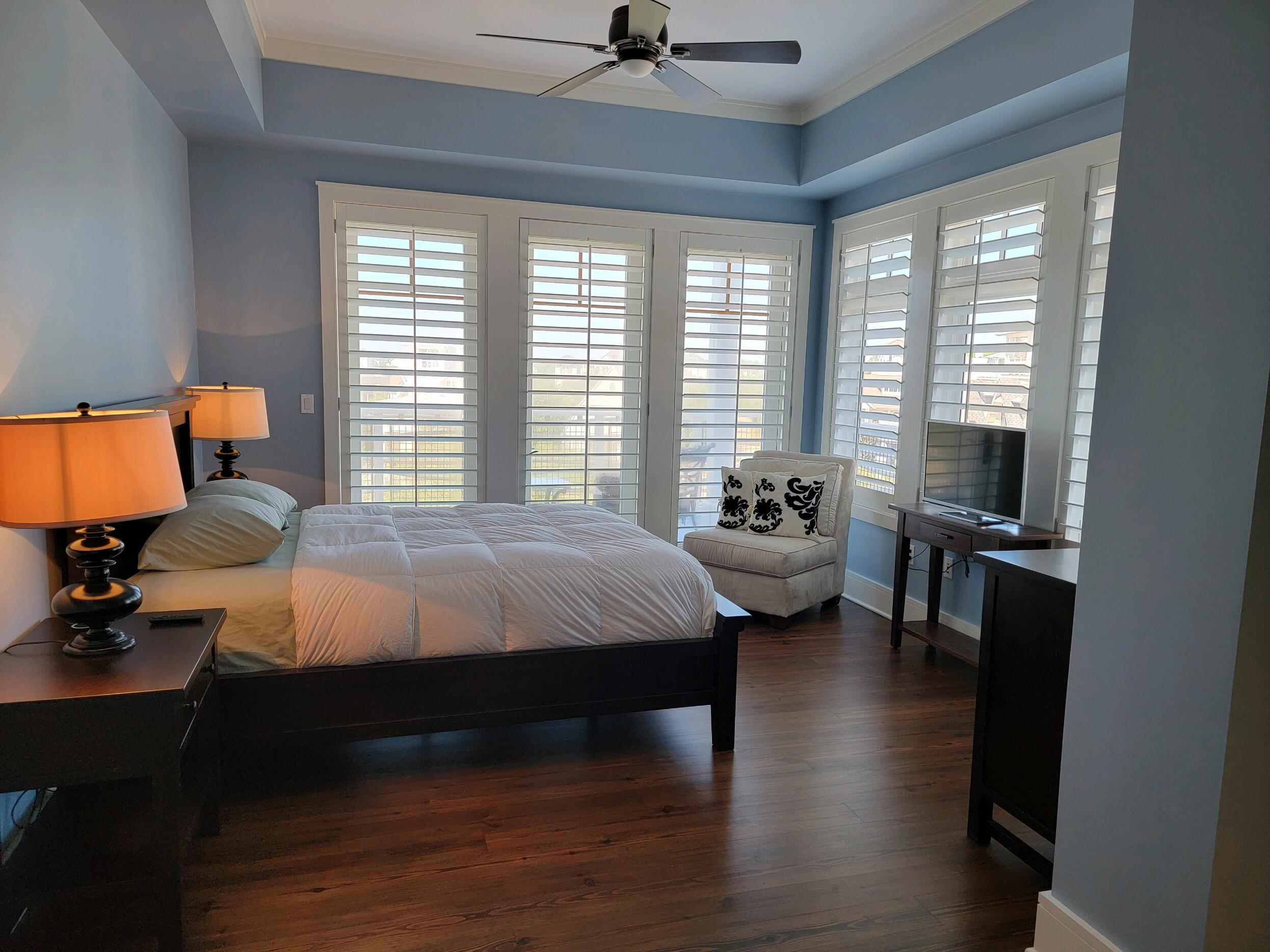 99 Compass Point Way South, Unit 402 Inlet Beach, FL 32461 - Photo 23 of 36 a bedroom with a bed couch and window