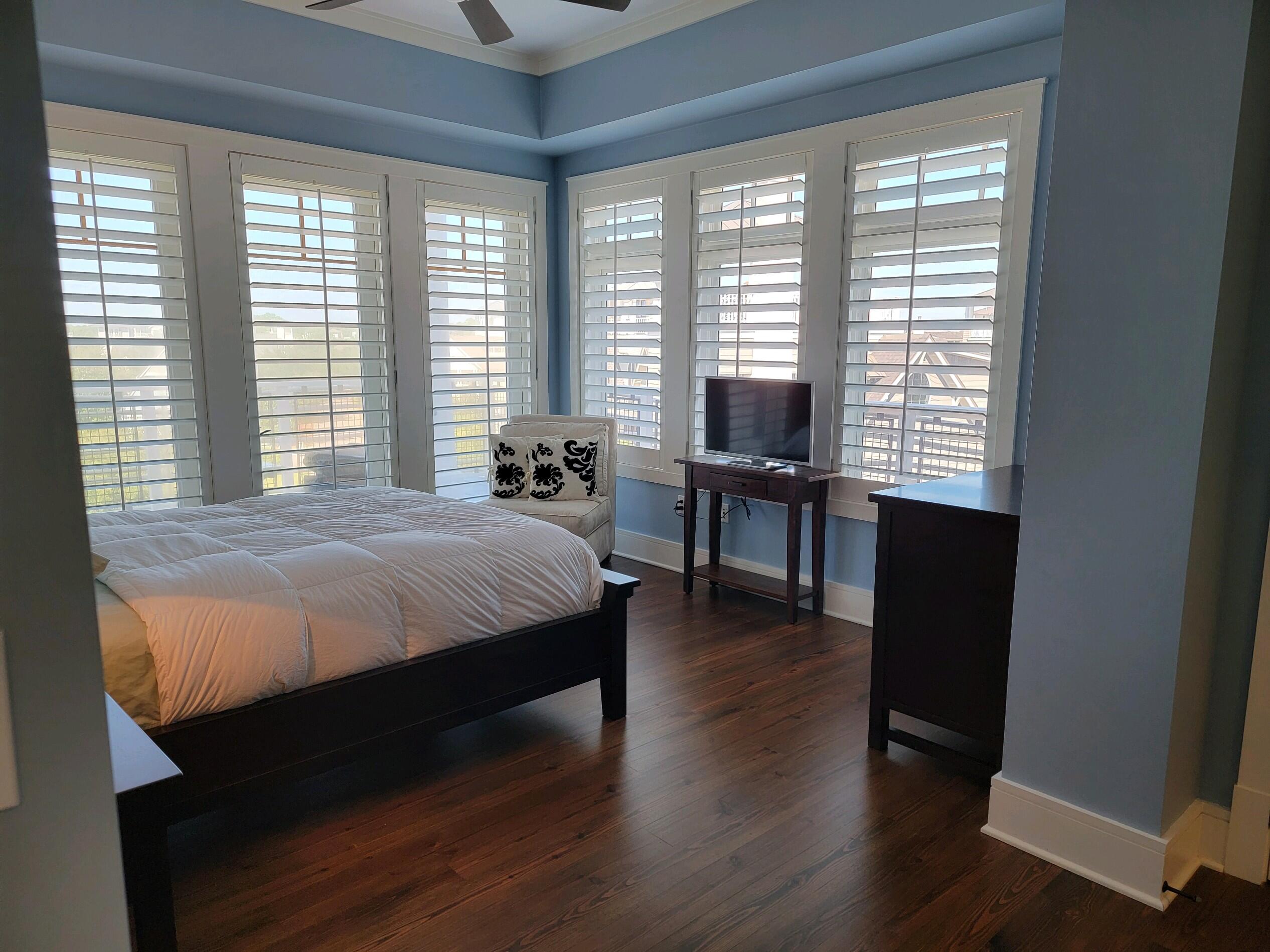99 Compass Point Way South, Unit 402 Inlet Beach, FL 32461 - Photo 24 of 36 a bed sitting in a bedroom next to a window