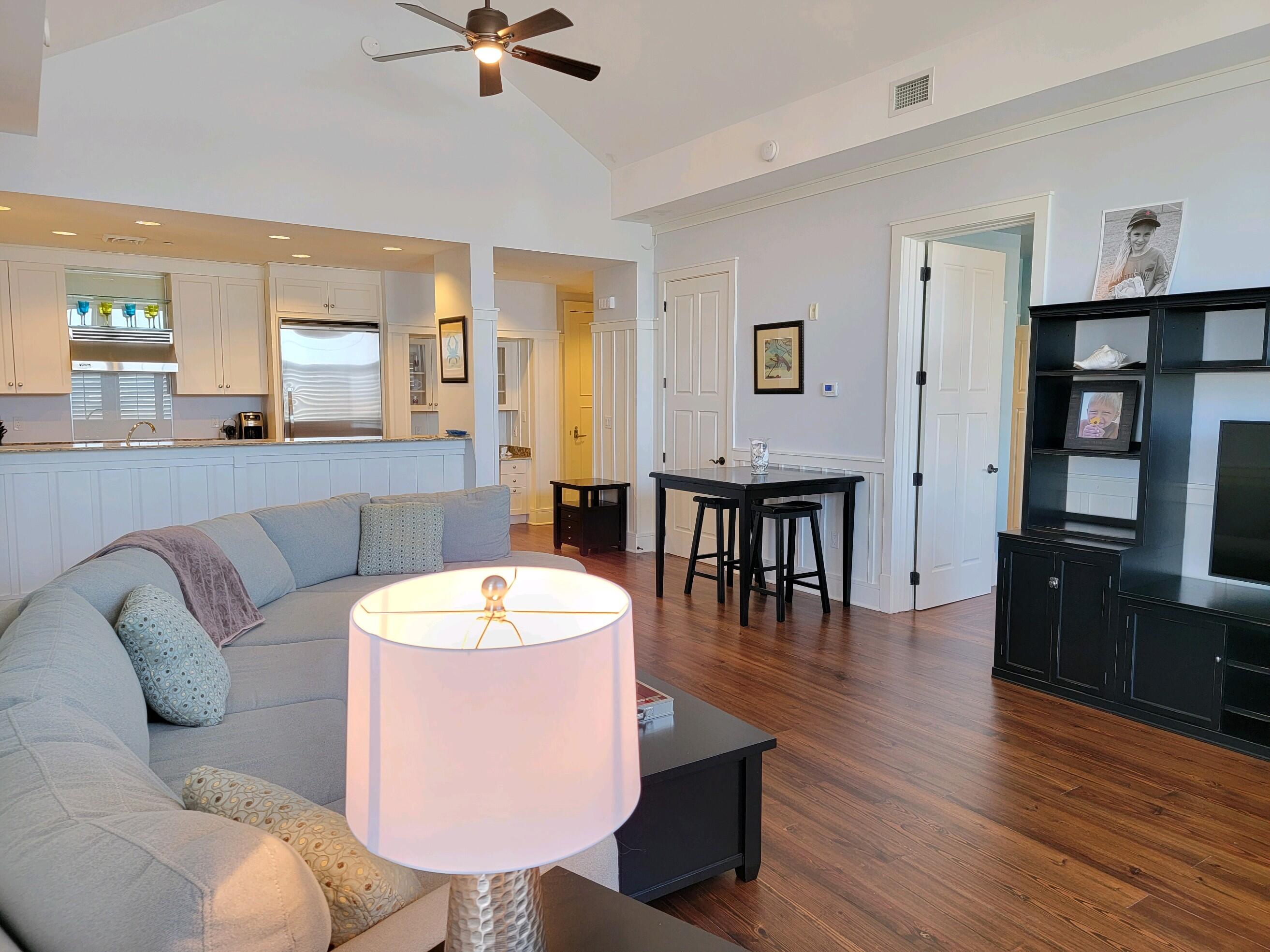 99 Compass Point Way South, Unit 402 Inlet Beach, FL 32461 - Photo 31 of 36 a living room with furniture a window and wooden floor