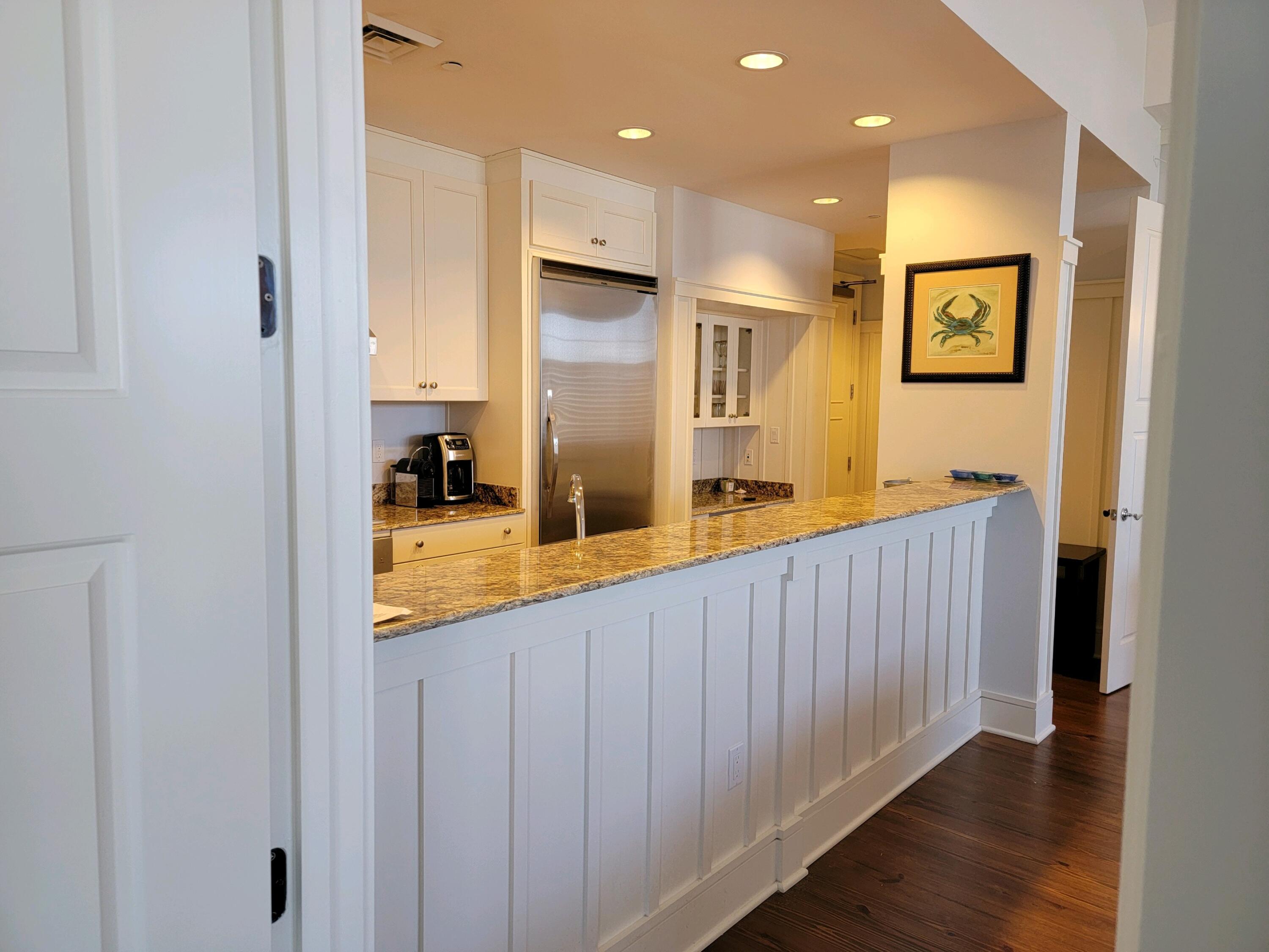 99 Compass Point Way South, Unit 402 Inlet Beach, FL 32461 - Photo 34 of 36 a view of a kitchen with stainless steel appliances granite countertop a sink and wooden floor