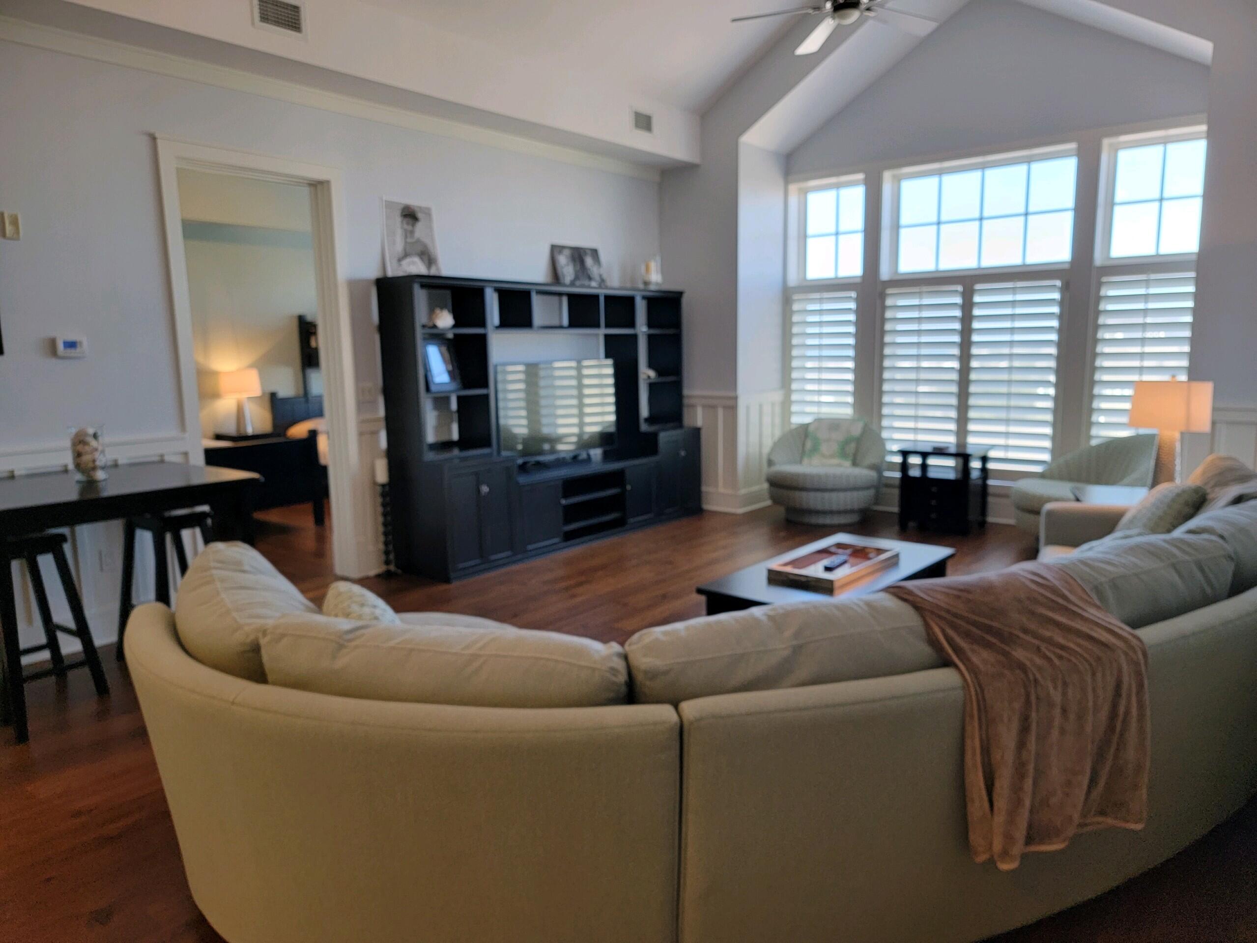 99 Compass Point Way South, Unit 402 Inlet Beach, FL 32461 - Photo 35 of 36 a living room with furniture and a flat screen tv