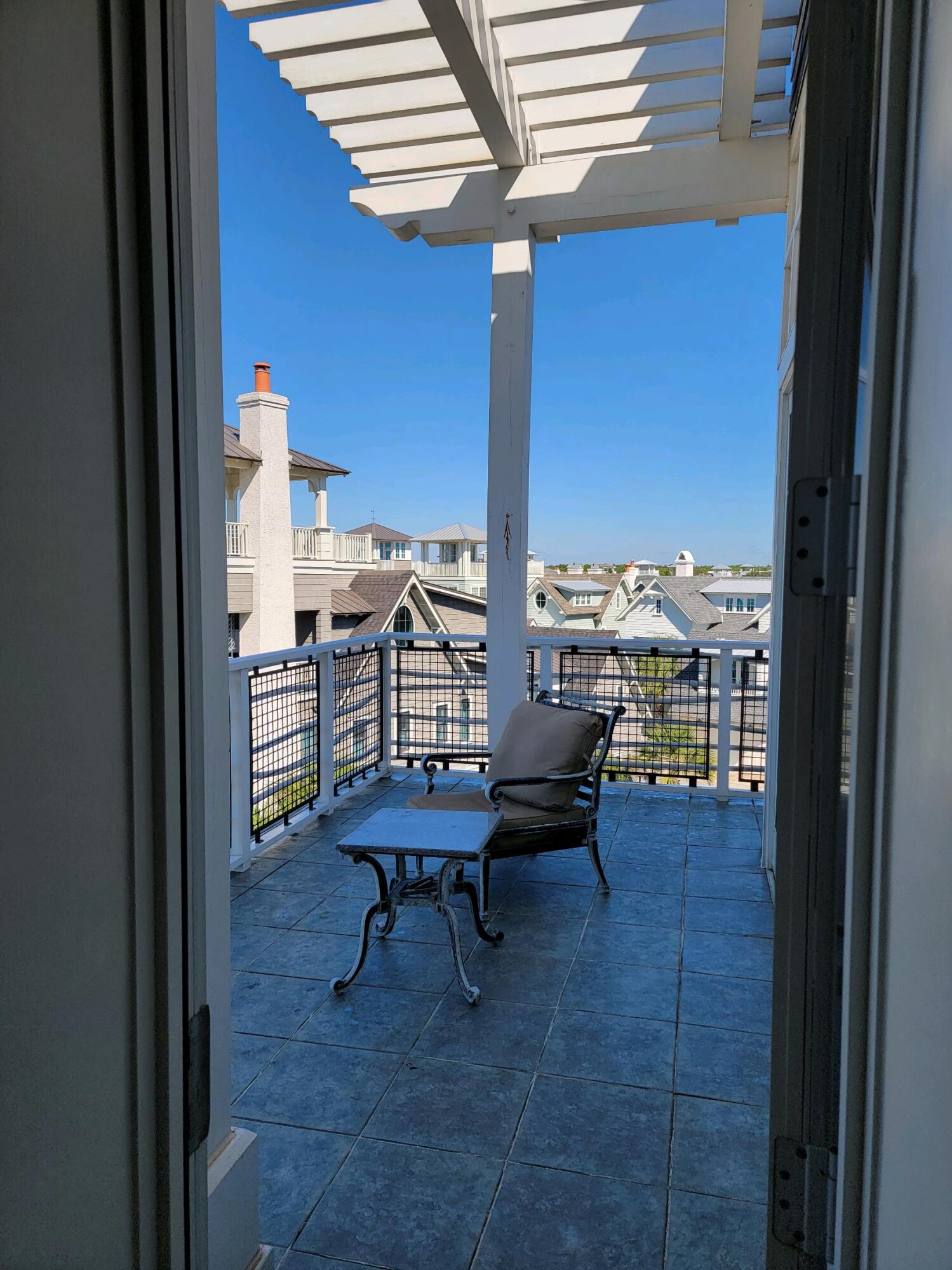 99 Compass Point Way South, Unit 402 Inlet Beach, FL 32461 - Photo 6 of 36 a view of a balcony with chairs
