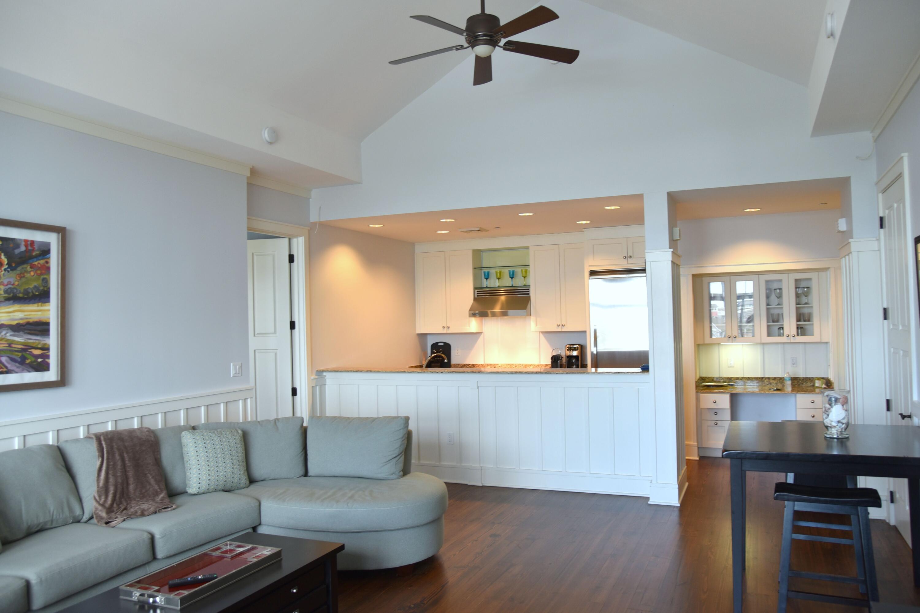 99 Compass Point Way South, Unit 402 Inlet Beach, FL 32461 - Photo 9 of 36 a living room with a couch and a view of kitchen