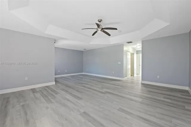 a view of a hallway with wooden floor and closet