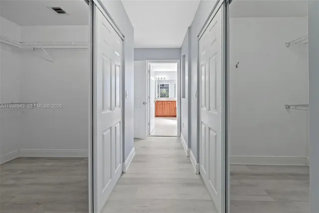 a spacious bathroom with a tub sink and mirror
