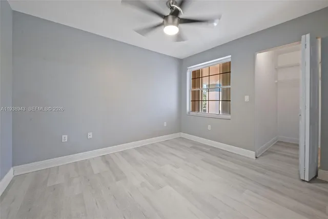 a bathroom with a granite countertop toilet a mirror and a sink