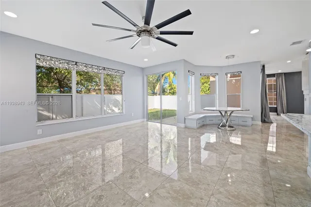 a kitchen with stainless steel appliances granite countertop a sink a stove a refrigerator and a oven