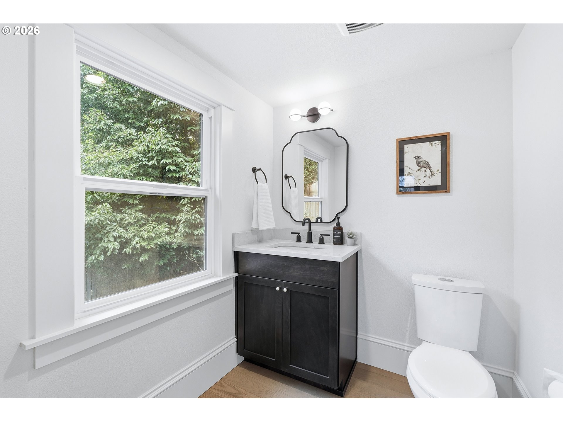 2125 Northwest 33rd Avenue Portland, OR 97210 - Photo 19 of 46 a bathroom with a toilet a sink and a mirror
