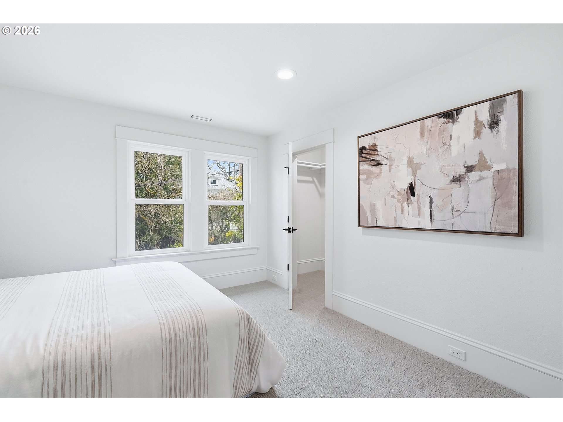 2125 Northwest 33rd Avenue Portland, OR 97210 - Photo 28 of 46 a spacious bedroom with a large bed and a window