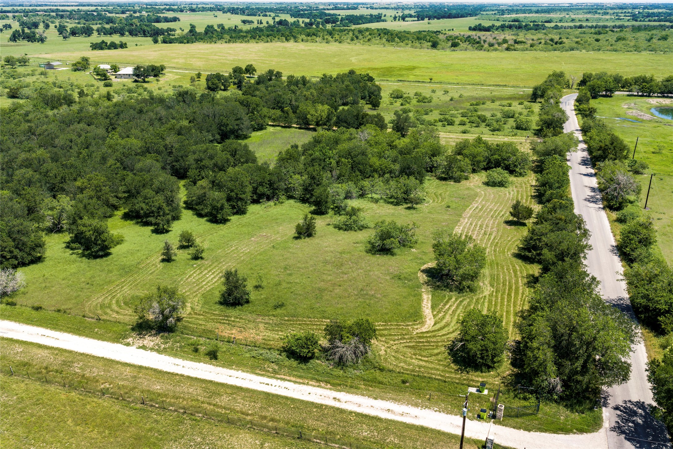 928 Upper Elgin River Road Elgin, TX 78621 - Photo 4 of 40 Expansive acreage featuring a mix of open grass areas and mature trees.