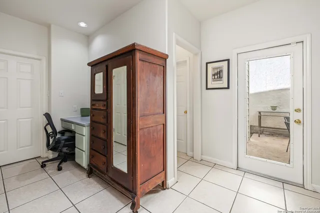 a view of kitchen with furniture and a refrigerator