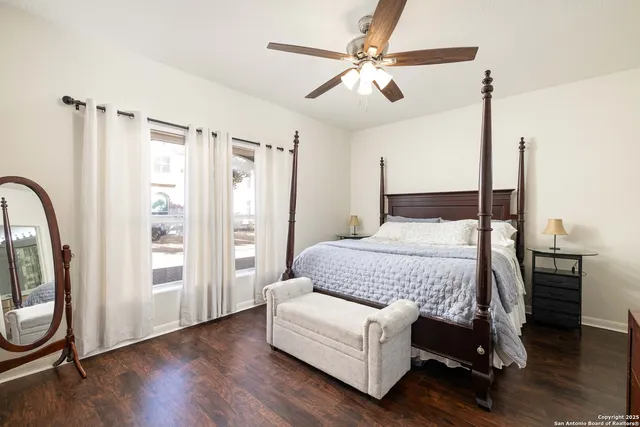 a bedroom with a bed wooden floor and window