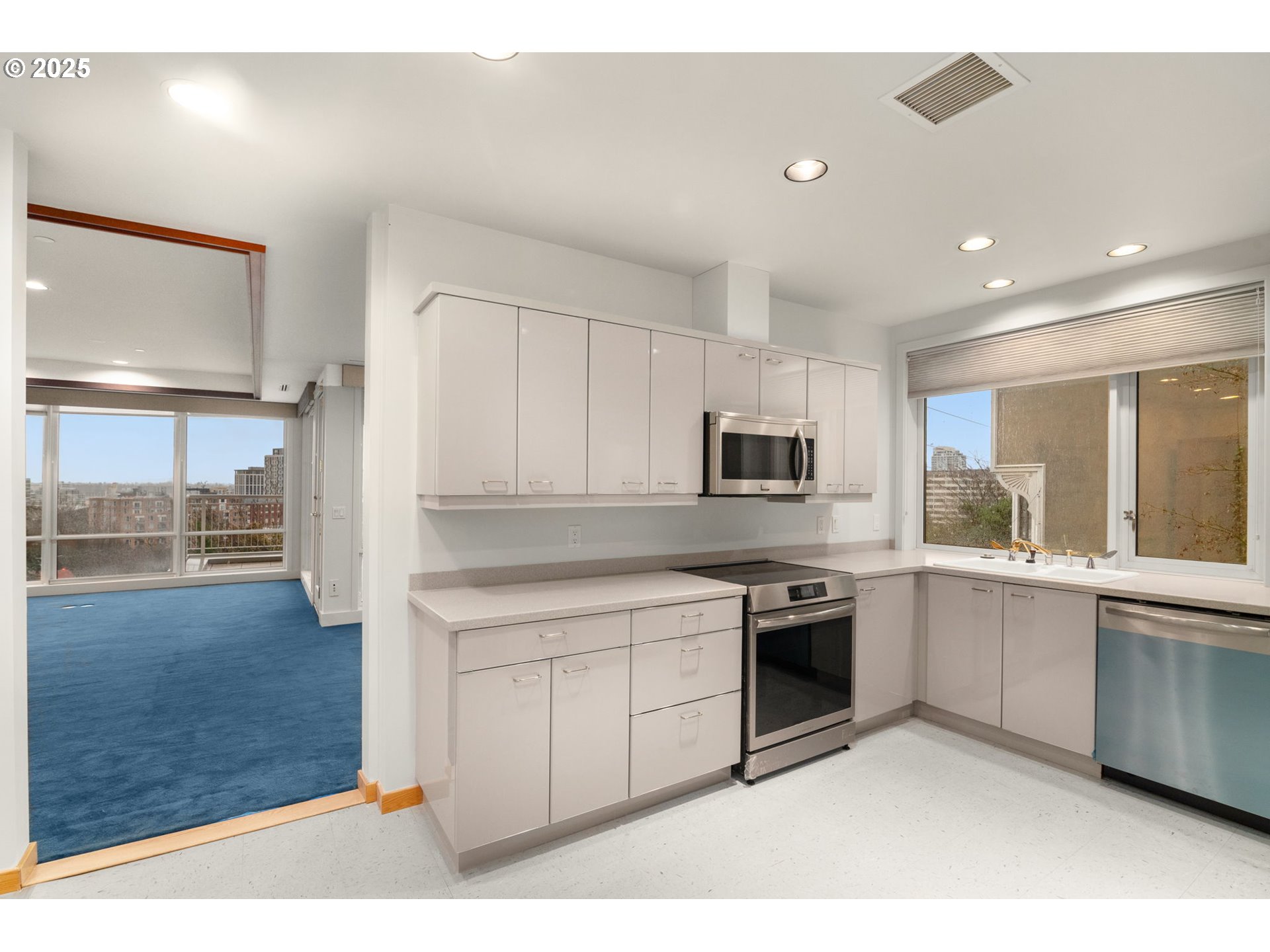 2020 Southwest Market St Drive, Unit 101 Portland, OR 97201 - Photo 13 of 33 a kitchen with stainless steel appliances granite countertop a stove a sink and a refrigerator