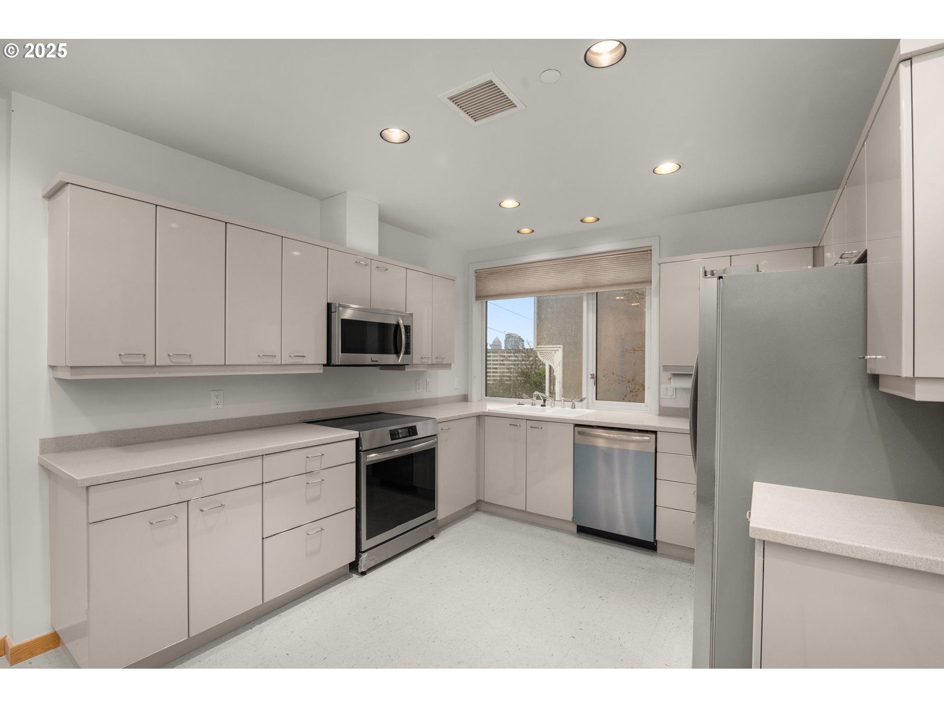 2020 Southwest Market St Drive, Unit 101 Portland, OR 97201 - Photo 14 of 33 a kitchen with cabinets and stainless steel appliances