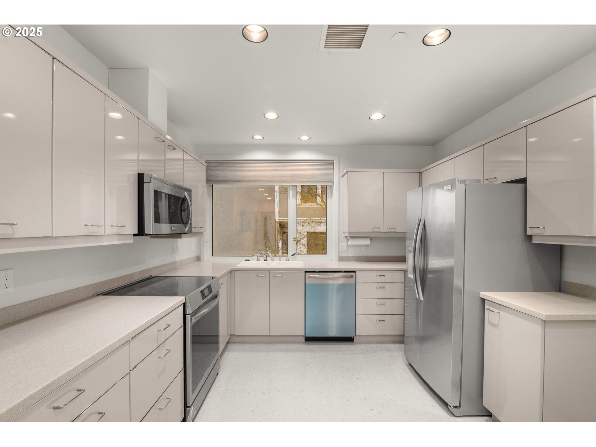 2020 Southwest Market St Drive, Unit 101 Portland, OR 97201 - Photo 16 of 33 a kitchen with a sink stainless steel appliances and cabinets