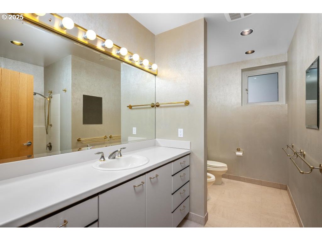 2020 Southwest Market St Drive, Unit 101 Portland, OR 97201 - Photo 24 of 33 a bathroom with a sink a toilet and mirror