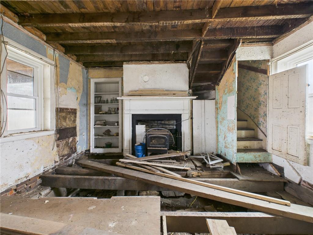 3698 Frew Mill Road New Castle, PA 16101 - Photo 13 of 25 a living room with a fireplace windows and ceiling fan