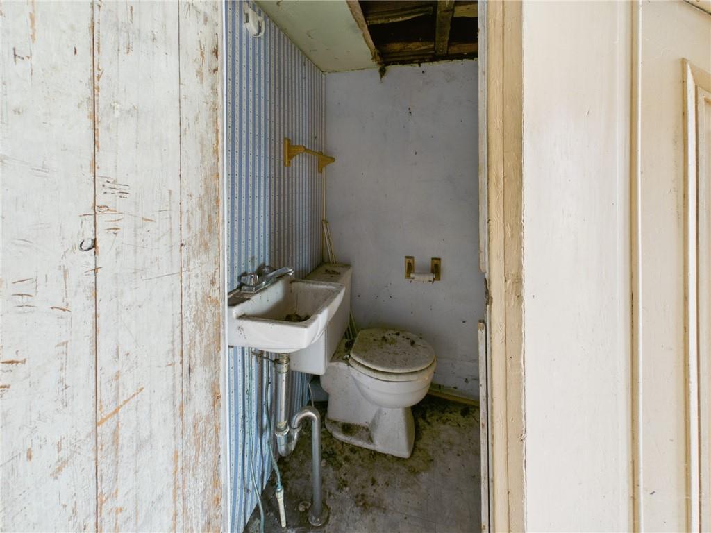 3698 Frew Mill Road New Castle, PA 16101 - Photo 25 of 25 a white toilet sitting next to a bathroom sink