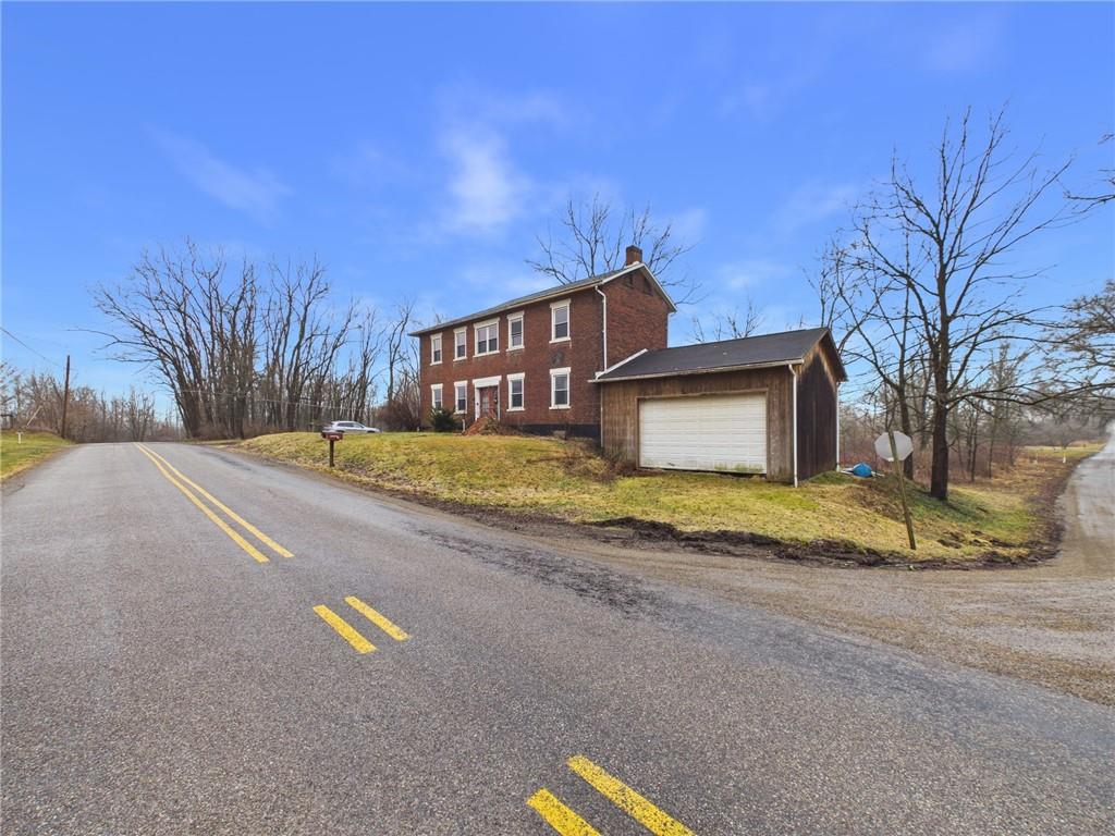 3698 Frew Mill Road New Castle, PA 16101 - Photo 4 of 25 a view of a house with a yard and garage