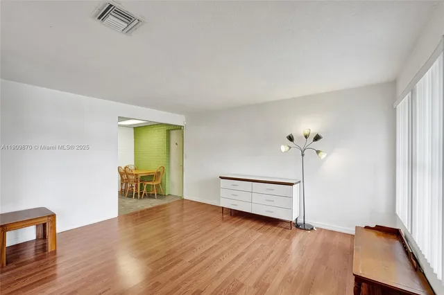 a living room with furniture a ceiling fan and a window